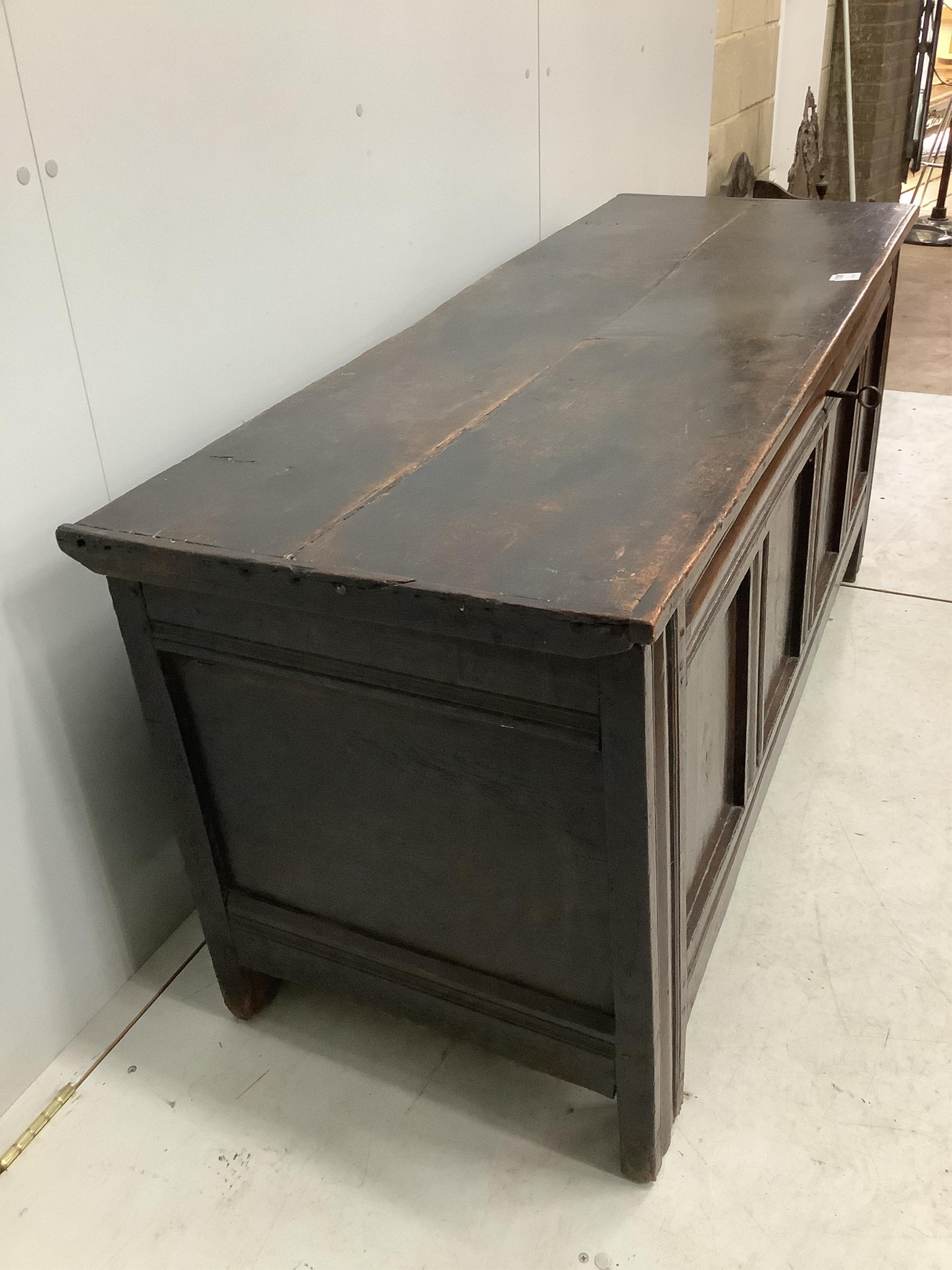 An early 18th century panelled oak coffer, width 151cm, depth 54cm, height 66cm. Condition - poor to fair